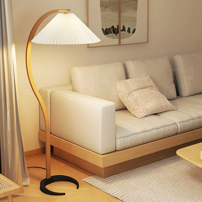 Geschwungene Holz-Stehlampe mit plissiertem Lampenschirm